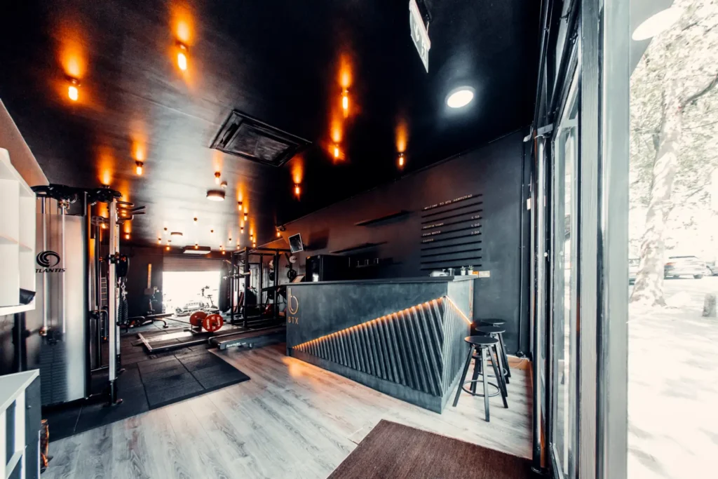 The BTX studio from the front: reception counter, warm pendant lights and the rig behind