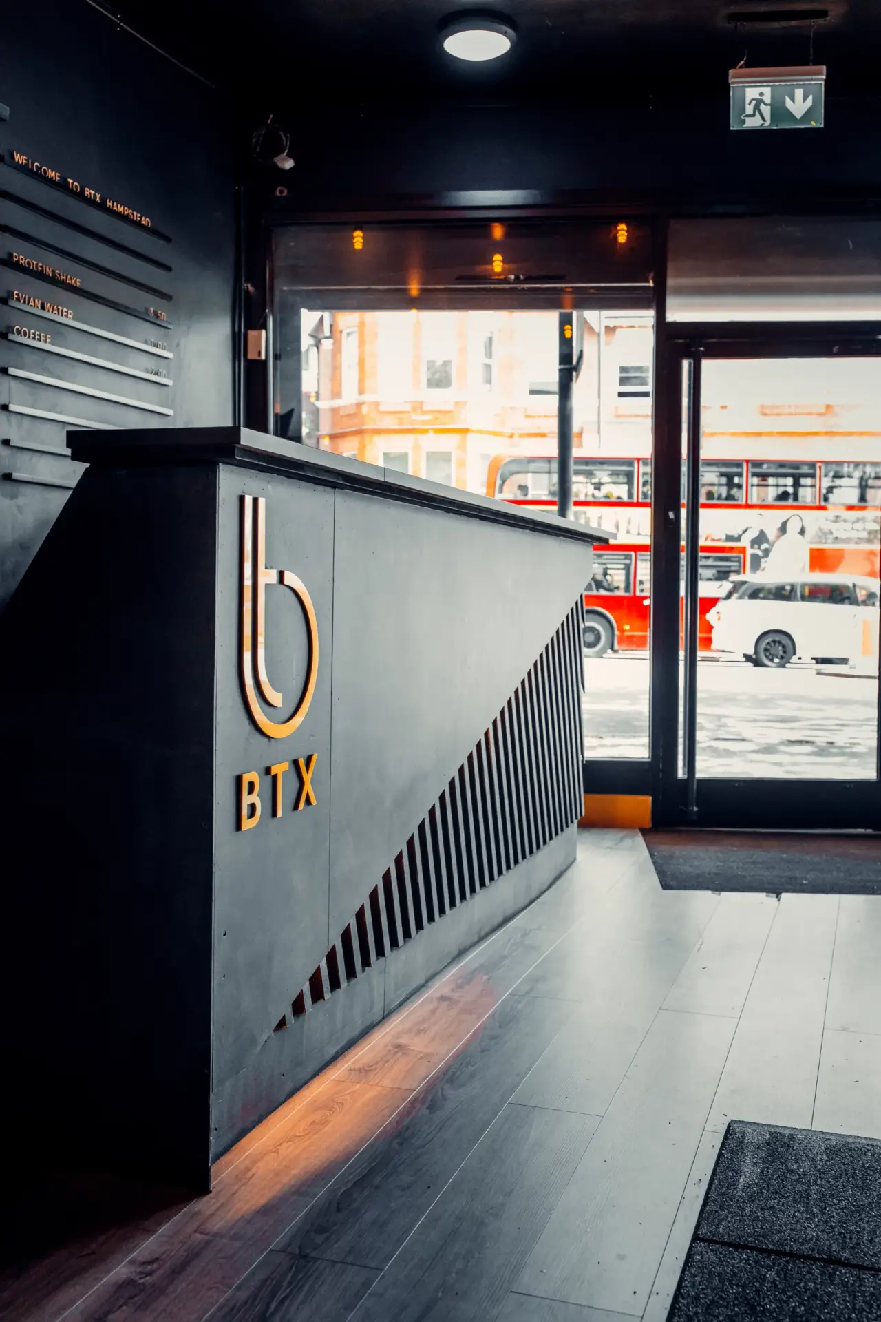 BTX reception desk with the gold BTX logo, Finchley Road through the window